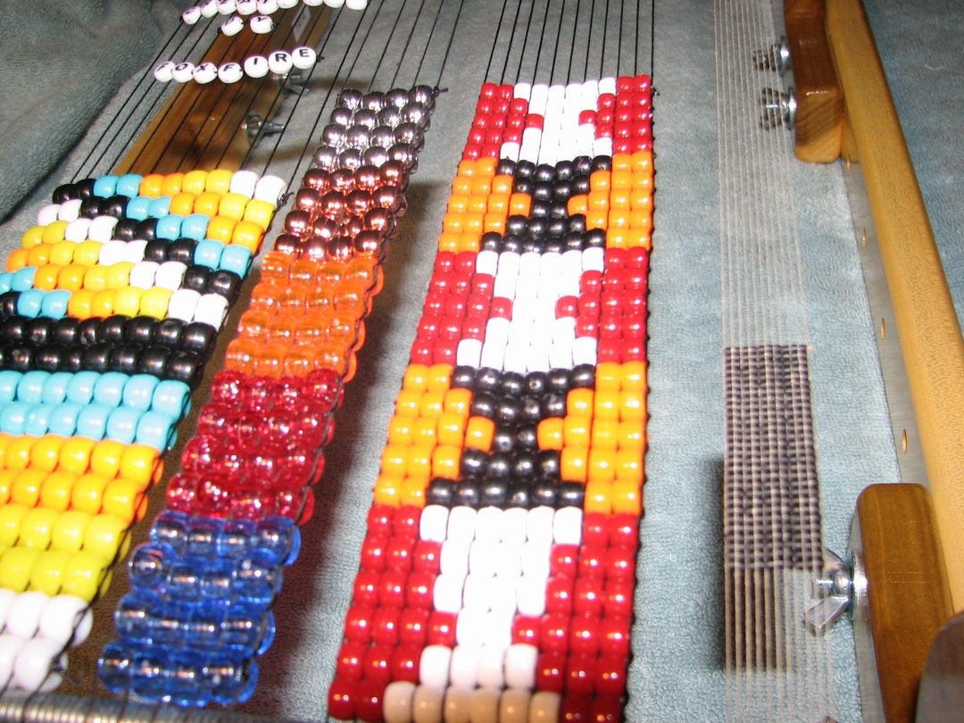 Close-up of colorful loomed beadwork rows held tight on the warp threads