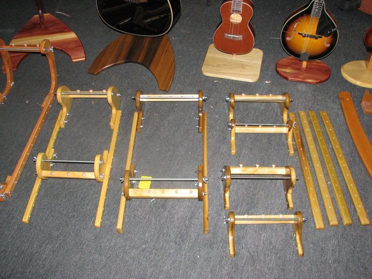 Several unfinished wood looms of different sizes laid out on the workshop floor